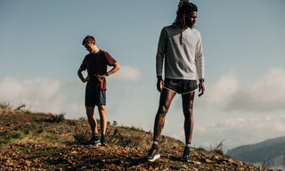 Two runners looking out over the Marin Headlands and Golden Gate Bridge while resting