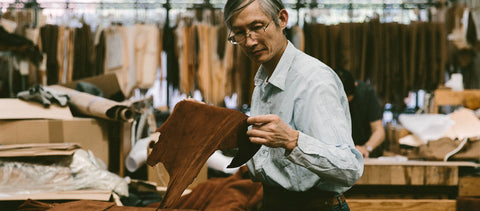 Garment patterns and templates hanging on a rack.