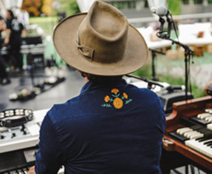 Keyboardist wearing our Better Together embroidered Western Shirt on stage from the back