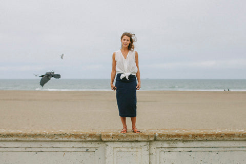 
Modeling The Samantha, standing on a sea wall, gulls flying around in the background.