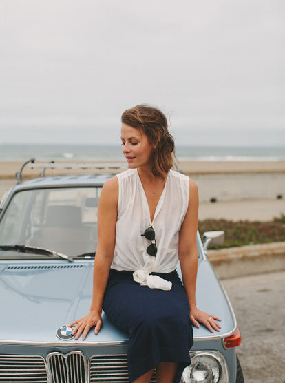 Modeling The Samantha, sitting on the hood of a classic BMW.