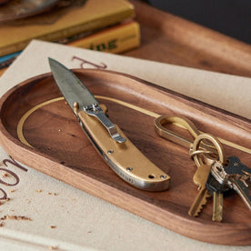 The Drop Point Knife in Brass on the valet tray, Accessories by Taylor Stitch