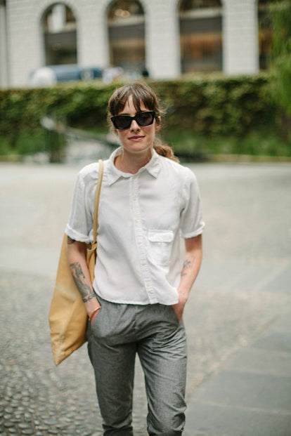 Modelling the pants - yellow tote bag over shoulder, front view.