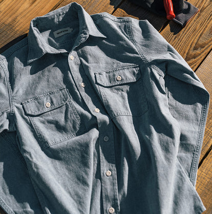 Volunteer working in a greenhouse wearing The Chore Shirt in Washed Indigo Boss Duck