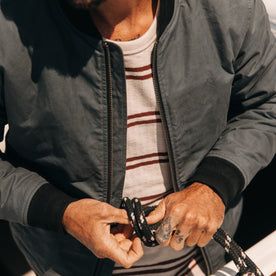 fit model tying a sailing line in The Bomber Jacket in Charcoal Dry Wax, Outerwear by Taylor Stitch