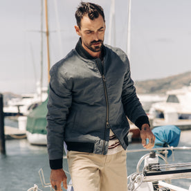 fit model walking on a boat in The Bomber Jacket in Charcoal Dry Wax, Outerwear by Taylor Stitch