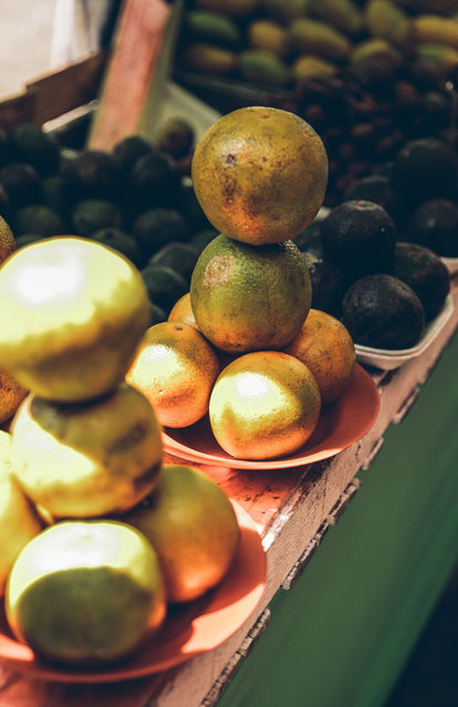 Fruits stacked up for sale on a market stall.