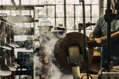 shot of our hat being made third image in the carousel—capturing the scene in the factory