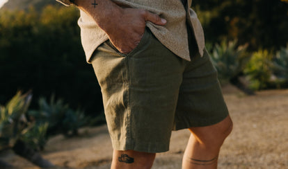 fit model with his hand in his pocket wearing The Easy Short in Olive Linen