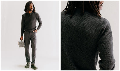 fit model posing in The Sidecountry Sweater in Heather Coal Merino