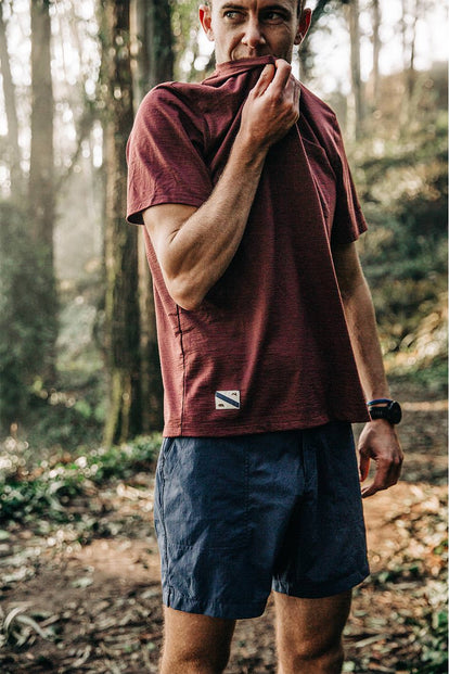 Our guy, standing on a forested trail.