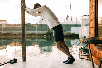 Our guy stretching on the deck of a house boat.