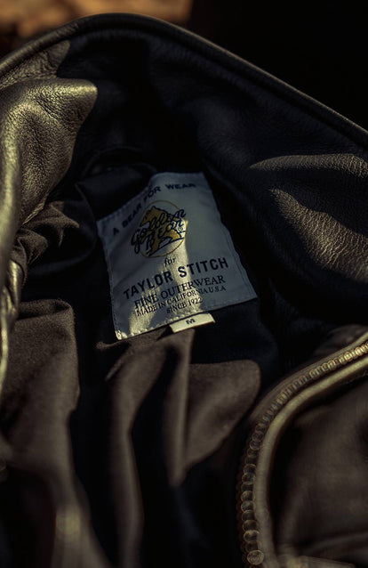 shot of ben in the forest with his jacket, close up of logo