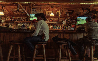 ben drinking a coke at a bar.