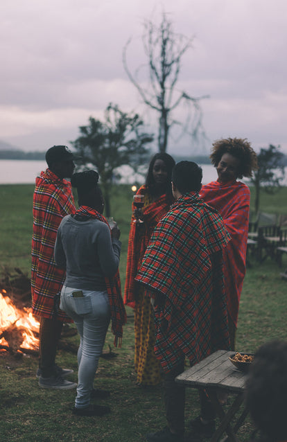 A group of African women, some wearing traditional dress, others wearing a combination of denim and traditional dress.