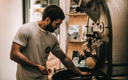 Nico checking the beans in a roasting machine.