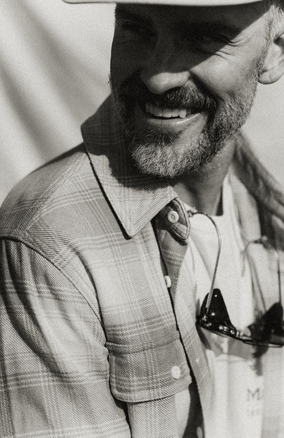 Our guy smiling in The Ledge Shirt in Sunrise Plaid