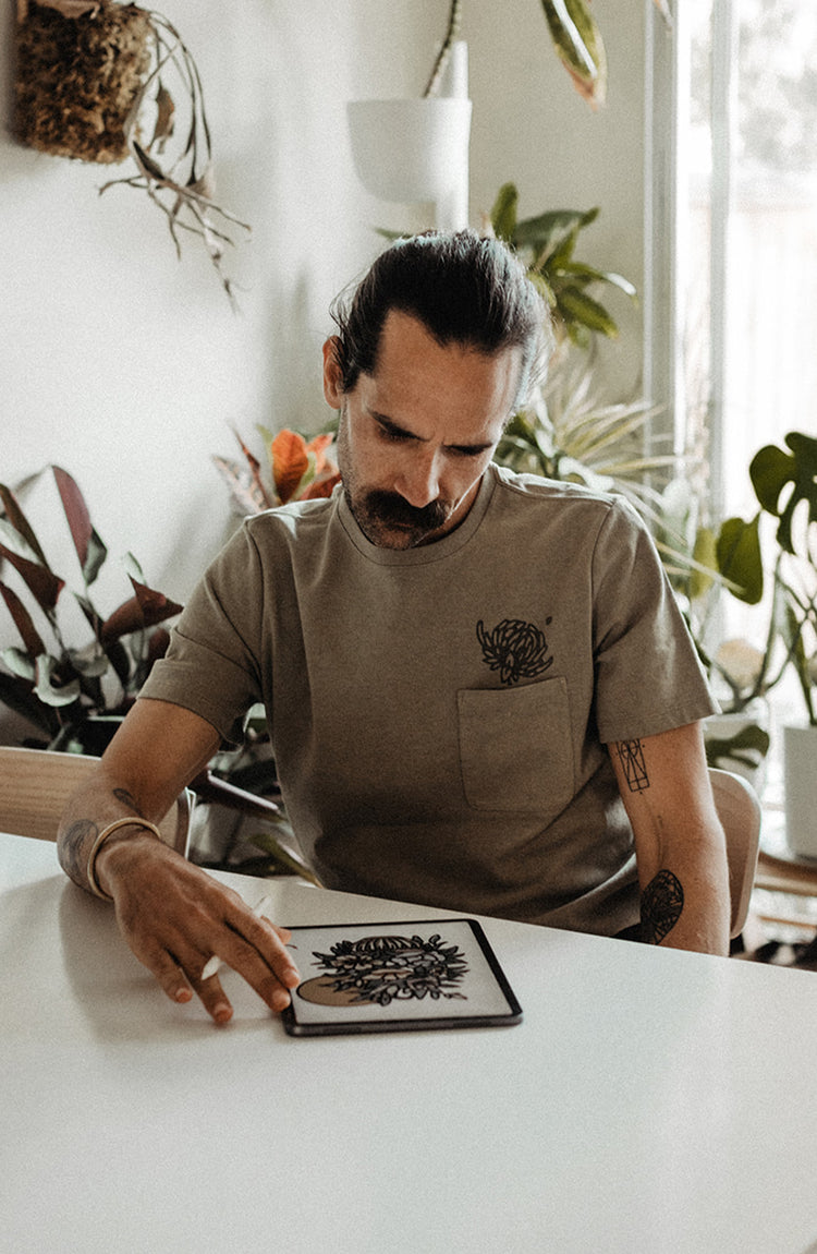 shot of daren sketching in his notebook.