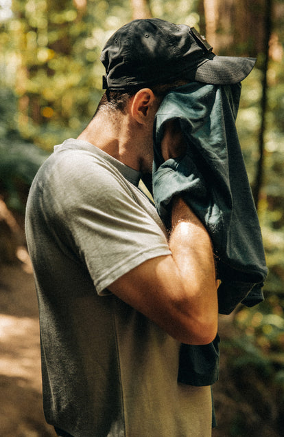 fit model showing off the sleeves on The Merino Base Layer Tee in Sharkskin