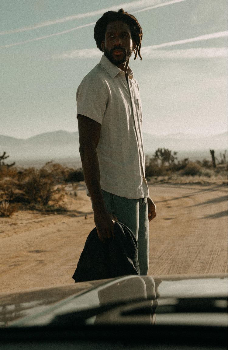 fit model standing on a road wearing The Short Sleeve California in Heather Ash Pointelle Stripe