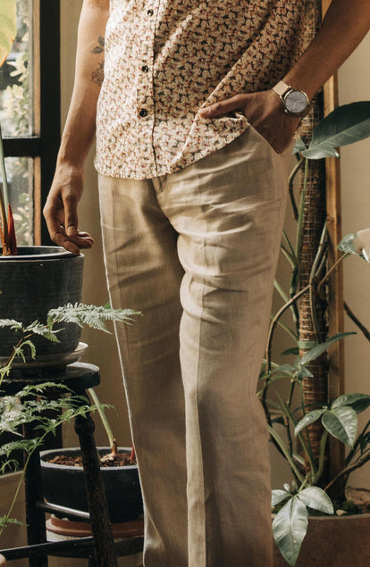 our guy walking in The Sheffield Trouser in Natural Linen in california, cropped shot with text on the right