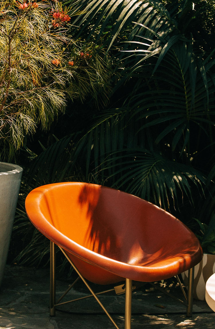 bright orange chair in a garden