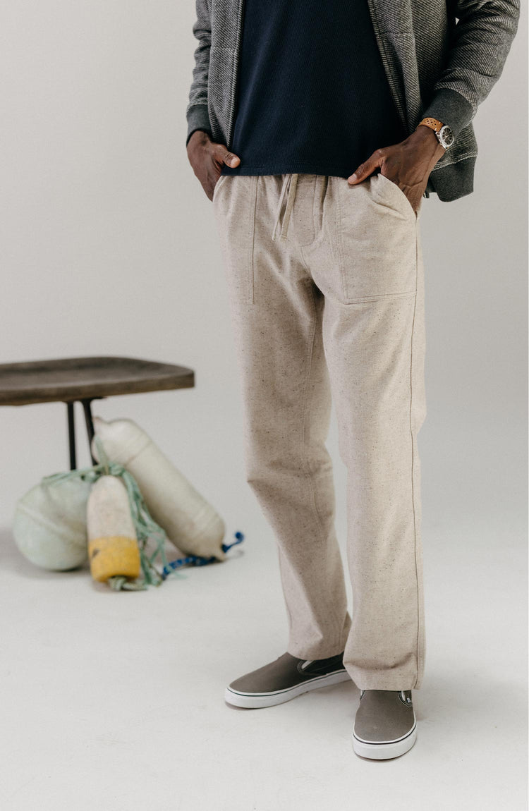 fit model with his hands in his pockets wearing The Breakwater Pant in Oat Donegal