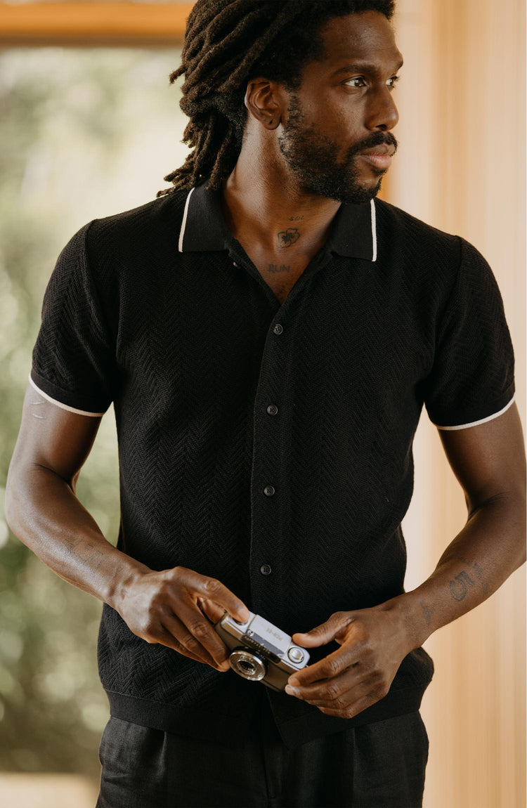 fit model posing in The Button Down Polo in Coal Herringbone