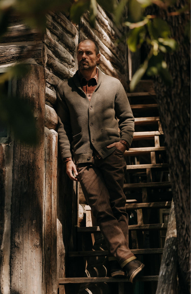 fit model on the stairs wearing The Crawford Sweater in Fatigue Olive