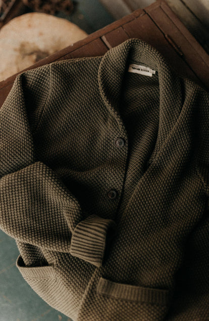 material shot of The Crawford Sweater in Fatigue Olive on a chair