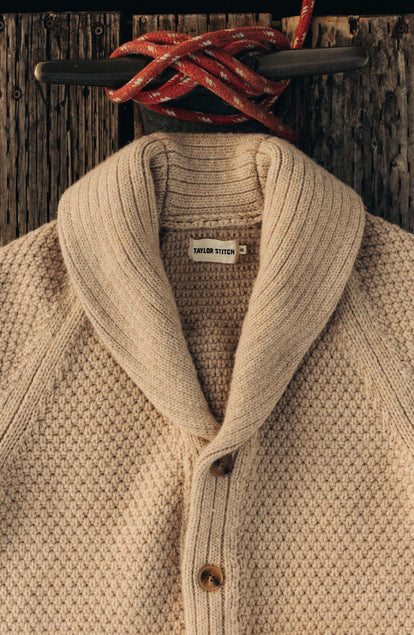 editorial flatlay of The Fisherman Shawl Cardigan in Heather Oat Merino