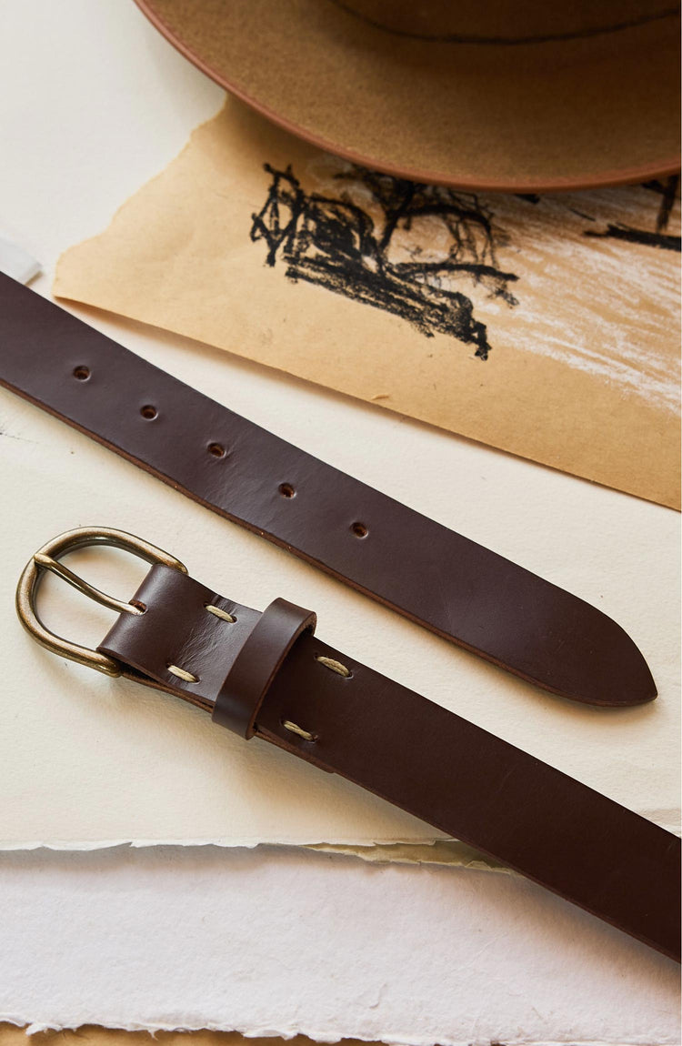 editorial image of The Foundation Belt in Dark Brown on stacks of paper