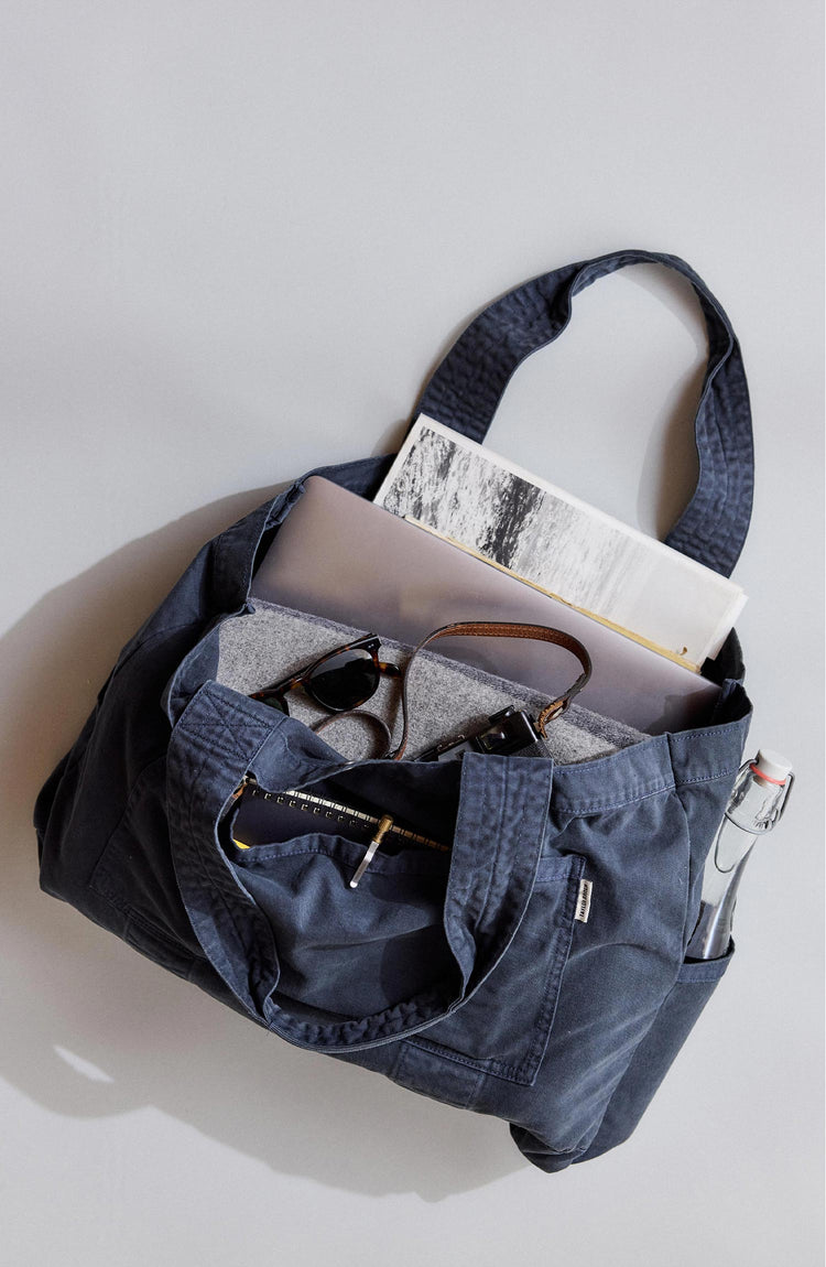 editorial image of The Foundation Tote in Organic Navy filled with items