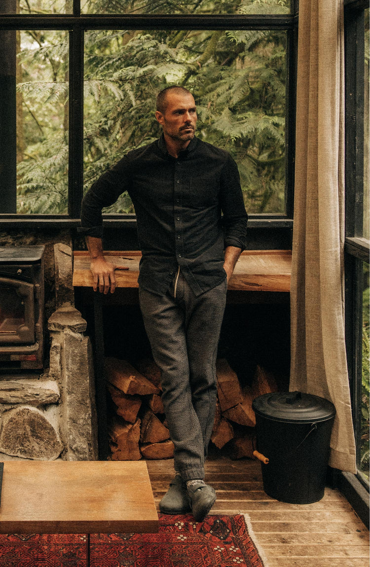 fit model leaning against a table wearing The Jack in Heather Coal Pincord