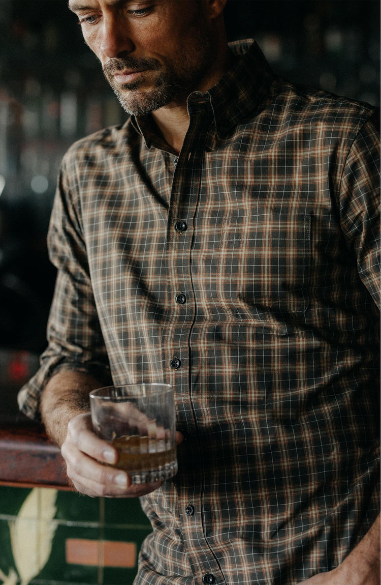 fit model holding a glass wearing The Jack in Mulch Plaid