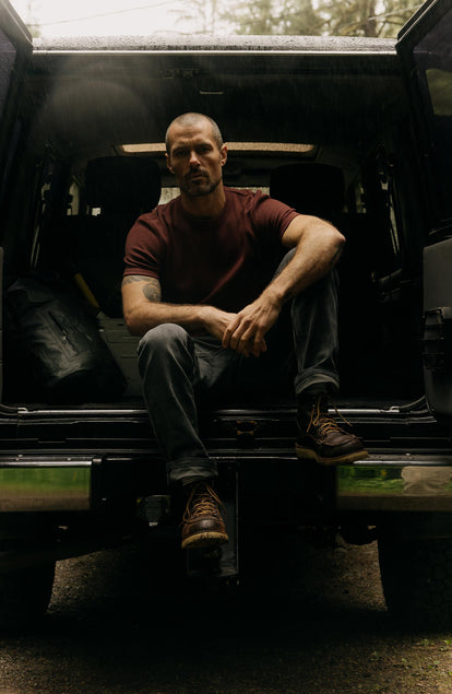 fit model sitting in a car wearing The Organic Cotton Short Sleeve Crew in Burgundy Waffle