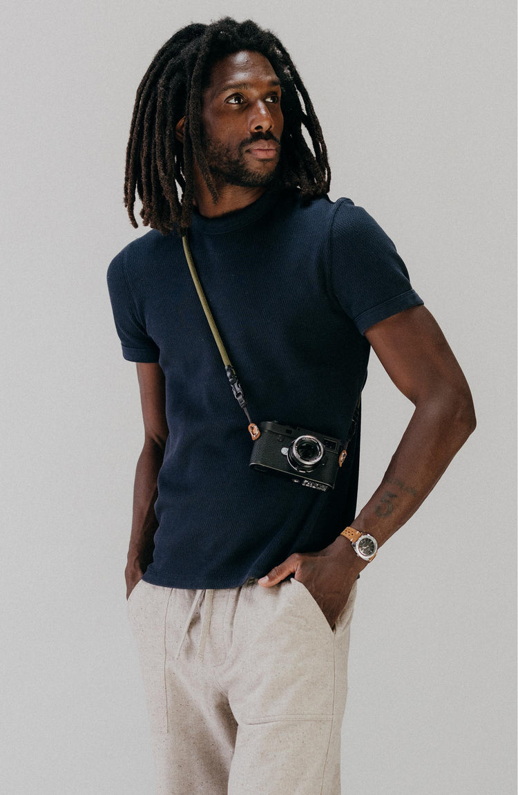 fit model with a camera around him wearing The Organic Cotton Short Sleeve Crew in Dark Navy Waffle