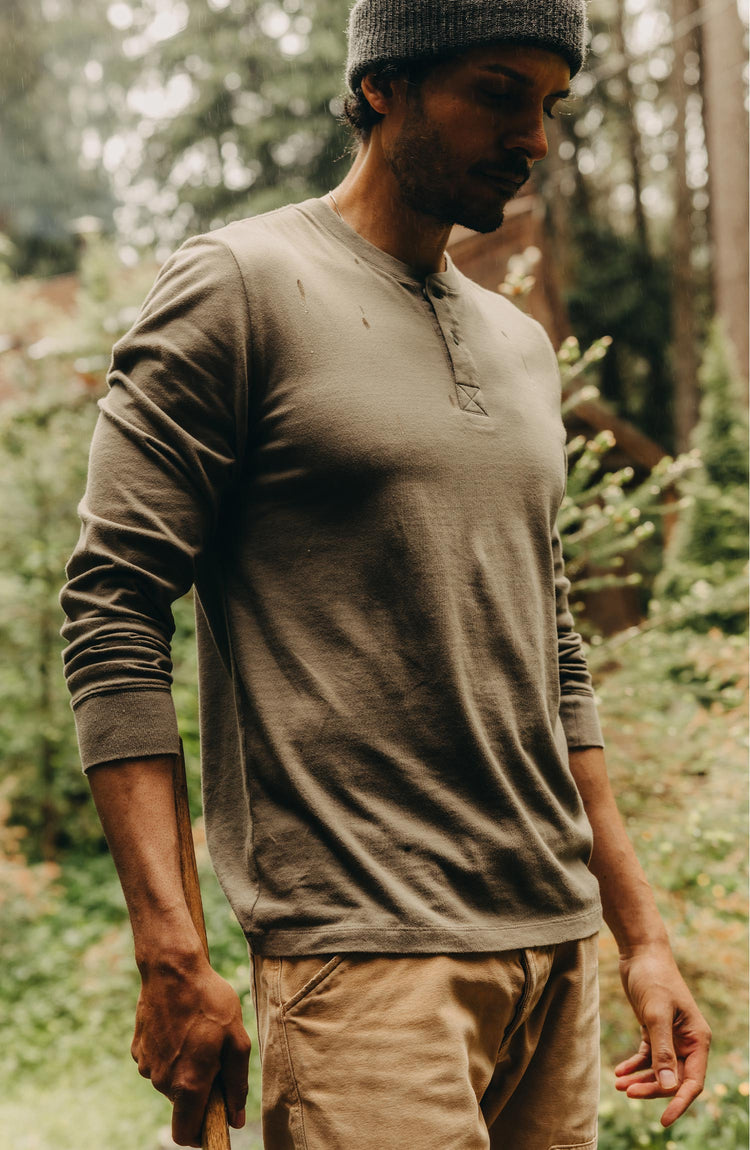 fit model walking wearing The Organic Cotton Henley in Sage