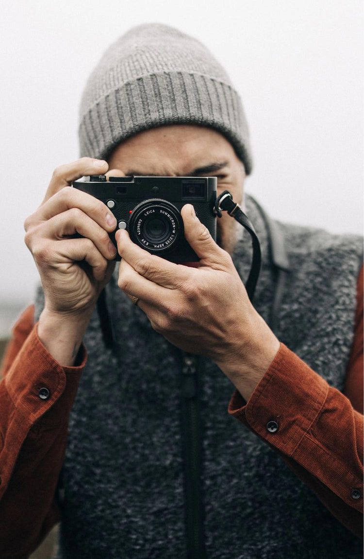 fit model taking a photo wearing The Port Vest in Coal Marl Boucle Fleece