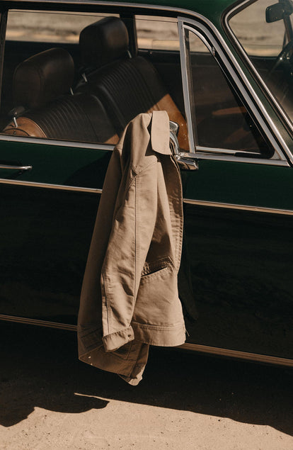 editorial image of The Tulum Shirt in Midnight Stripe on the ground next to a car