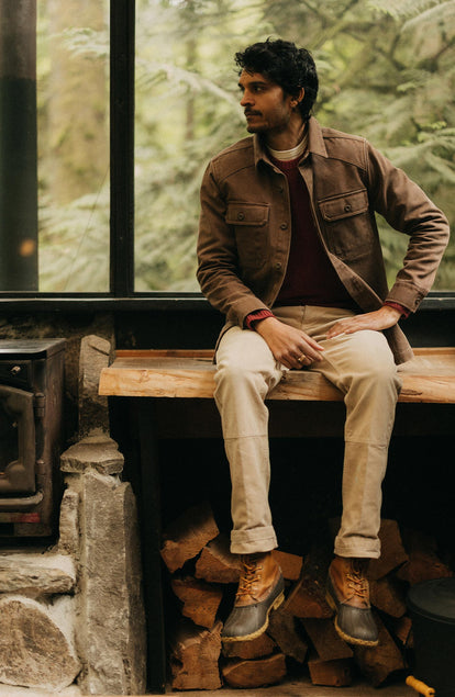 fit model sitting wearing The Shop Shirt in Aged Penny Chipped Canvas