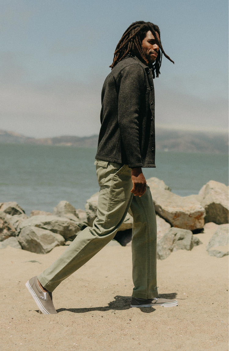 fit model walking wearing The Surplus Pant in Field Olive Reverse Sateen