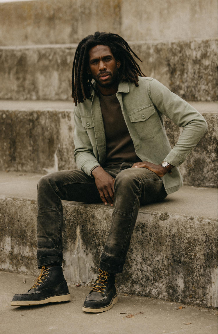 fit model sitting wearing The Surplus Shirt in Field Olive Reverse Sateen