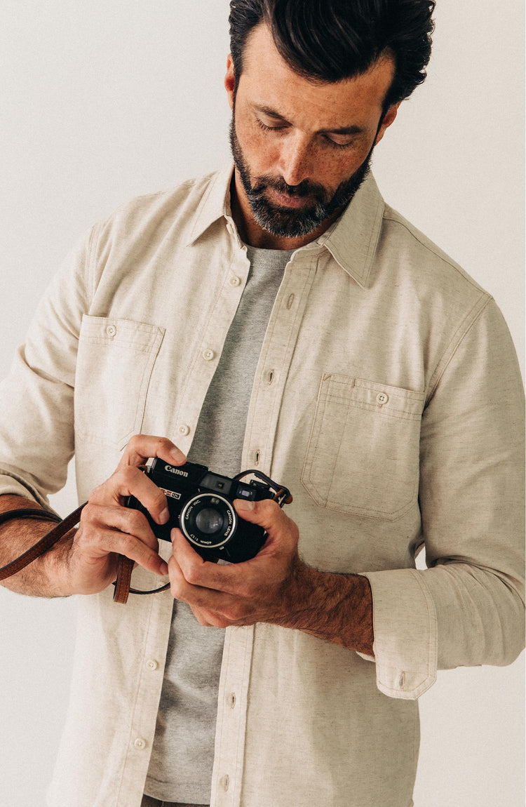 fit model holding a camera wearing The Utility Shirt in Natural Nep