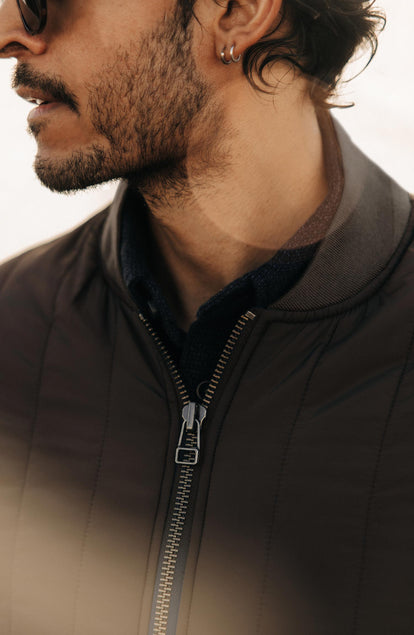 fit model showing off the collar on The Able Jacket in Soil Quilted Nylon