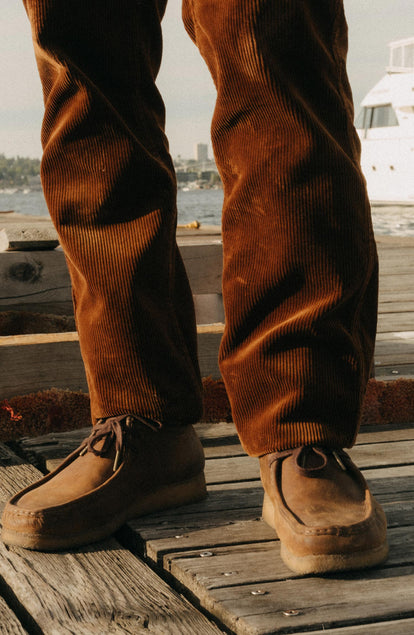 fit model showing off the bottom cuffs on The Carnegie Pant in Bourbon Corduroy