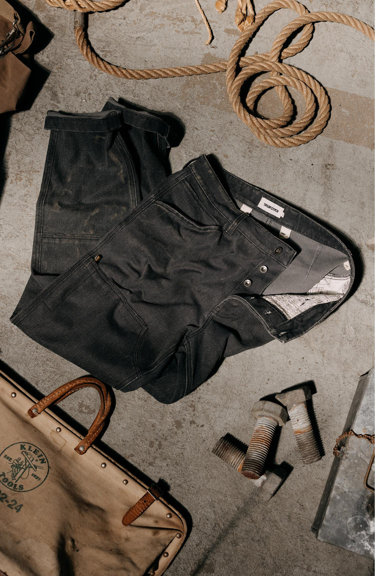 editorial image of The Chore Pant in Coal Chipped Canvas on the ground