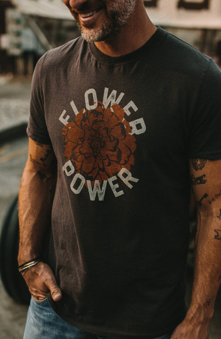 Model weraing The Cotton Hemp Tee in Flower Power in a work shed