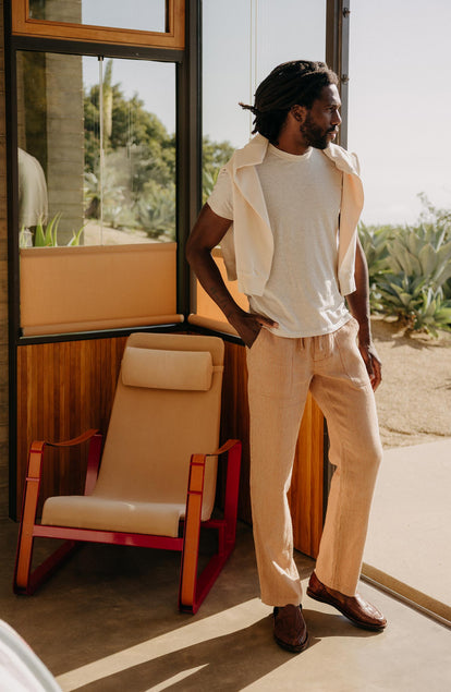 fit model leaning against the wall wearing The Cotton Hemp Tee in Heather Oat