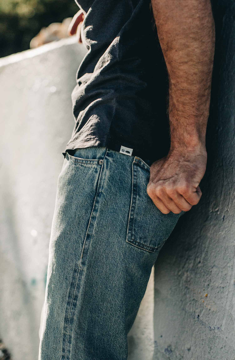 our fit model wearing the 24 month wash denim on the beach—cropped shot of pocket details